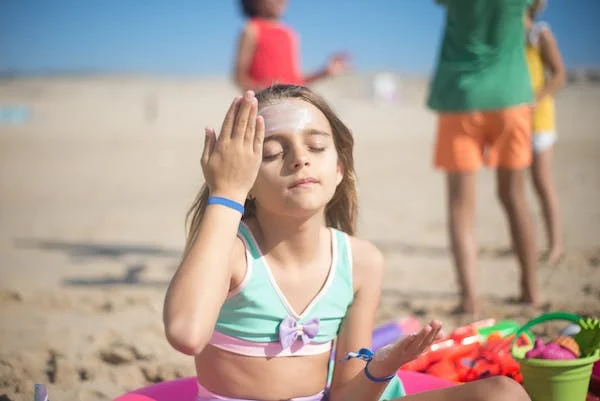 a girl applying sunscreen