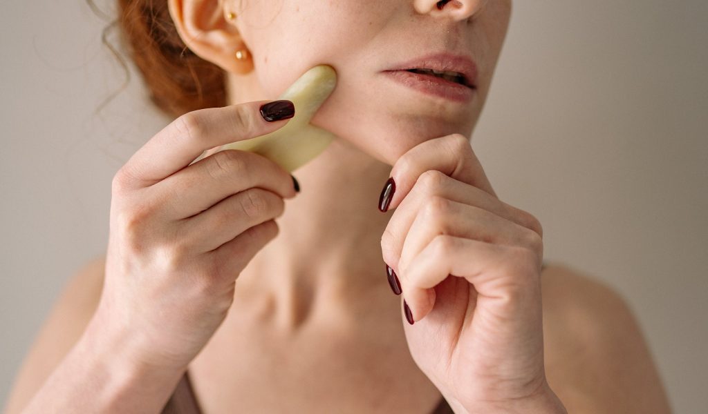 Glide the Gua Sha Across Your Skin At an Angle of 30 to 45 degrees.